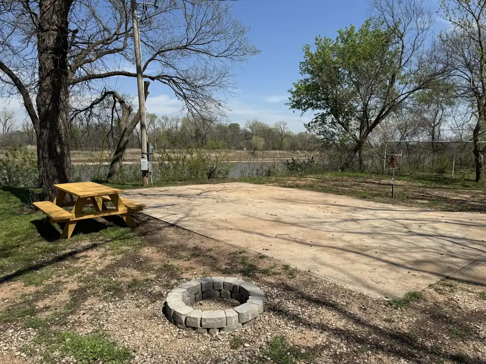 Riverfront RV site with fire pit at Rivershire